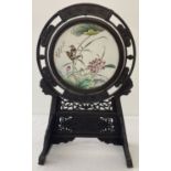 A dark wood framed Chinese ceramic rotating porcelain panel.