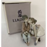 "Ten And Growing" figurine of a boy and girl by Lladro. Complete with original box.