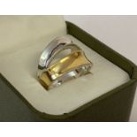 A duo coloured silver, modern design band ring. Marked 925 to inside of band.