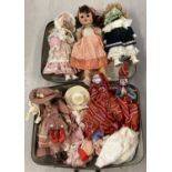 A case containing vintage and modern porcelain dolls, ethnic cloth dolls