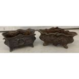 2 small cast iron four footed planters. With floral and wreath decoration.