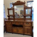 A large Victorian mirror backed side board with carved detail, turned finials & bevel edged glass.