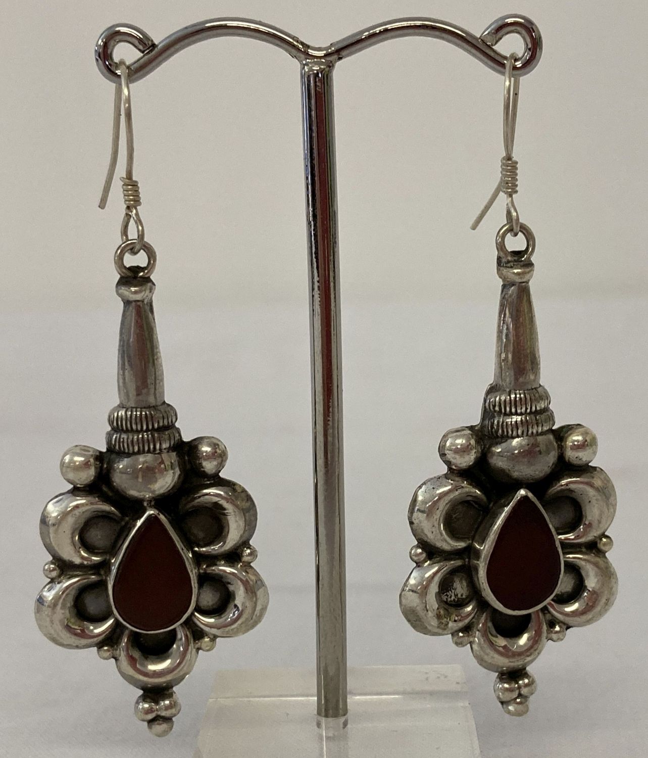 A pair of 925 silver drop earrings set with tear drop shaped carnelian stones.