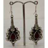 A pair of 925 silver drop earrings set with tear drop shaped carnelian stones.