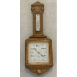 A vintage wall hanging wooden framed barometer by Army & Navy Store Ltd, London.