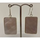 A pair of rectangular shaped silver mounted mother of pearl drop earrings.