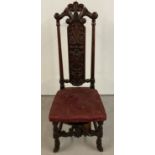 A mahogany carved high back bedroom chair with dark red upholstered seat.
