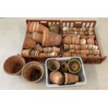 A large quantity of vintage terracotta plant pots in varying sizes and condition.