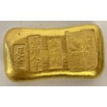 A Chinese gold coloured ingot with impressed mark and Chinese symbols.