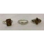 3 silver dress rings. 2 set with green amber and a twist style band ring. All marked 925.