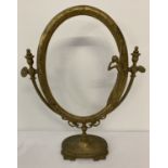 An Art Nouveau style oval shaped swivel frame on a pedestal stand.