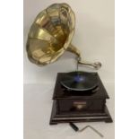 A wooden cased table top, wind up, trumpet gramophone marked "Victrola".