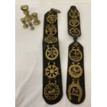 A collection of 12 horse brasses on leather straps together with 4 vintage bell weights.