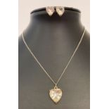 A matching heart shaped pendant and earrings set, with pale yellow coloured stones.