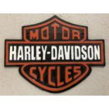 A black and red painted cast iron "Harley-Davison Motor Cycles wall plaque.