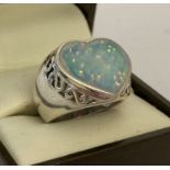 A 925 silver dress ring with pierced work detail and set with heart shaped opalite stone.