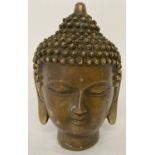 A hollow brass figurine of a Buddha head, with Chinese lettering to underside.