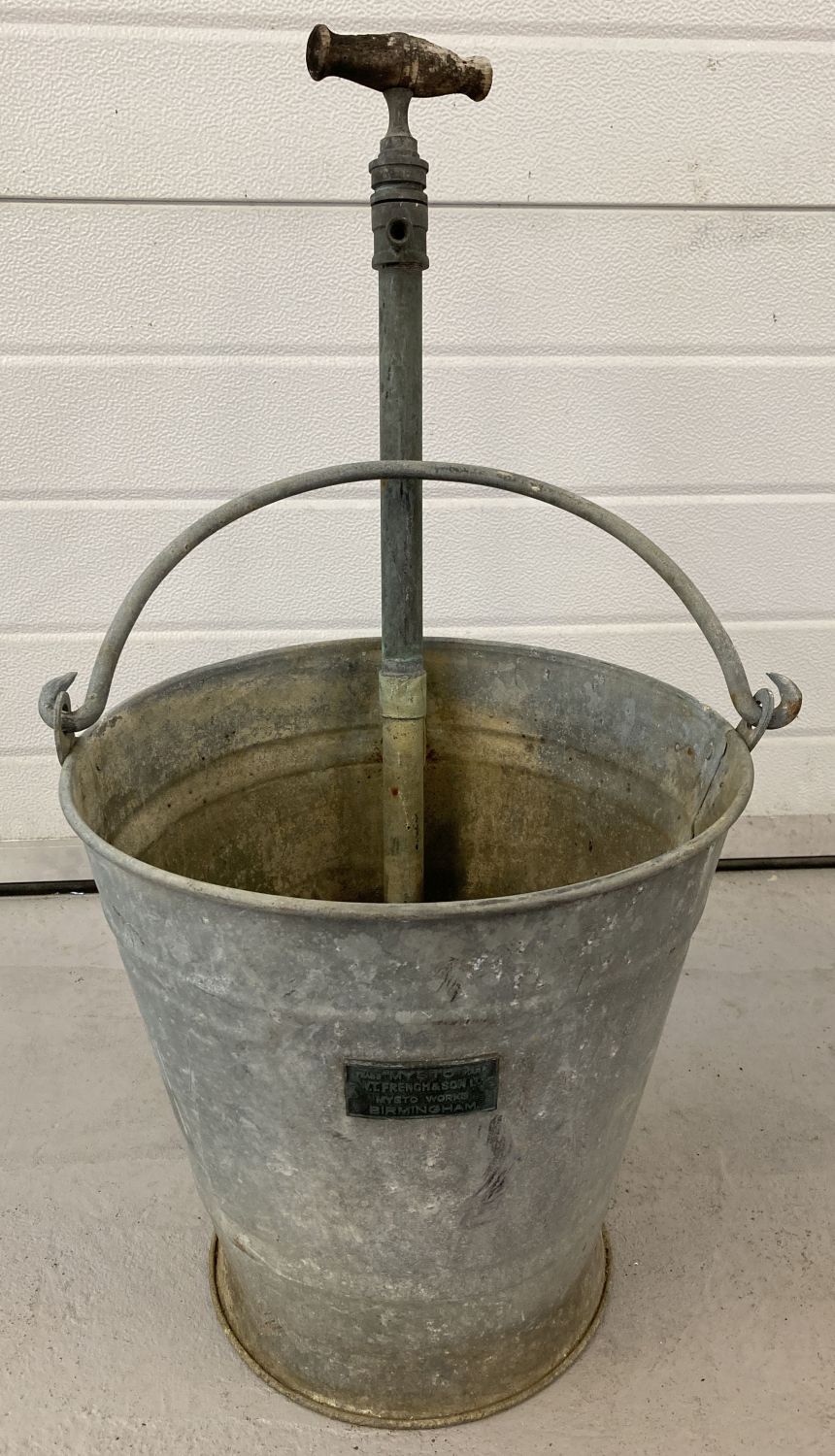 A vintage "Musto" galvanised stirrup pump bucket by W.T.French & Sons, Birmingham.