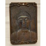 A rectangular shaped bronze pendant depicting Buddha with Chinese lettering to reverse.