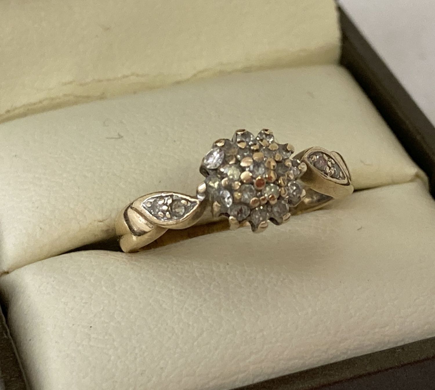 A 9ct gold .25 diamond cluster style dress ring. Full hallmarks to inside of band.