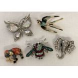 A collection of stone set and enamelled costume jewellery brooches.