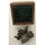 A replica wooden and glass lidded box containing a "Victorian Travelling Sextant" by Smith & Co.