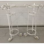 A pair of wrought iron tall plant stands painted white. Scroll design feet and decoration to tops.