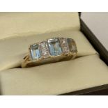 A 9ct gold blue topaz and diamond set dress ring by Luke Stockley, London.