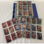 A folder containing a large quantity of assorted wrestling trading cards.