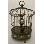 An ornamental wind up birdcage clock with cloisonné panel to base.