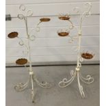 A pair of white painted metal garden small plant pot stands. Scroll design feet.
