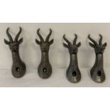 4 metal wall hooks in the shape of gazelle heads.