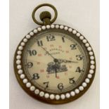 A brass cased pocket watch with beaded detail to surround front and back.