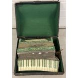 A vintage accordion by Casali, Verona, Italy. Green mother of pearl effect finish.