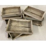 A collection of 9 vintage wooden seed trays.