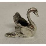 A small silver pin cushion in the form of a swan. Marked 925, with navy blue velvet cushion.