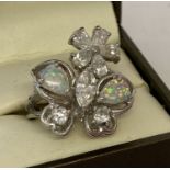 A 925 silver dress ring set with cubic zirconia and opal stones in the shape of a butterfly & flower
