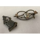 An antique silver rope knot sweetheart brooch with heart, flower and leaf detail.