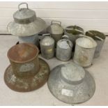 A collection of vintage galvanised poultry feeders.