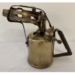 A vintage brass Burmos blow lamp.