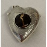 A silver heart shaped vesta case with central ceramic panel depicting a nude.