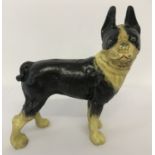 A cast iron figurine of a French Bulldog, in black and cream.