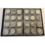 A folder containing 70 assorted white metal coins from around the world.