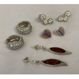 4 pairs of silver earrings in stud and drop styles.