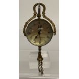 A brass bound ball watch pendant with tassel detail.