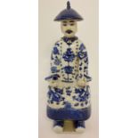 A Chinese ceramic blue and white figurine of a seated gentleman.