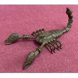 A small Japanese bronze articulated figure of a scorpion.