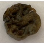 A carved jade roundel in the form of a dragon.