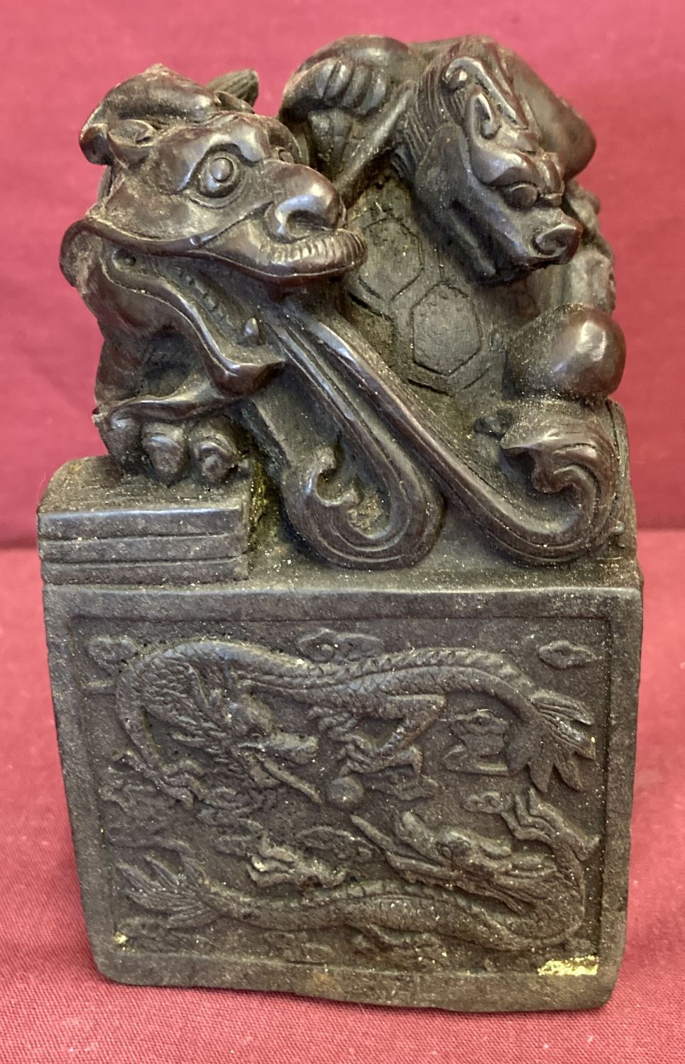 A large square shaped hollow bronze seal featuring a dragon turtle.