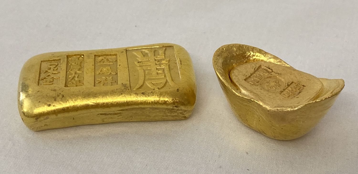 2 Chinese gold coloured metal Yuabao wealth ingots, with impressed Chinese markings and symbols.